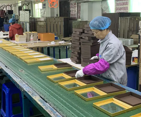 Manual assembly line for custom chocolate gift boxes with window packaging
