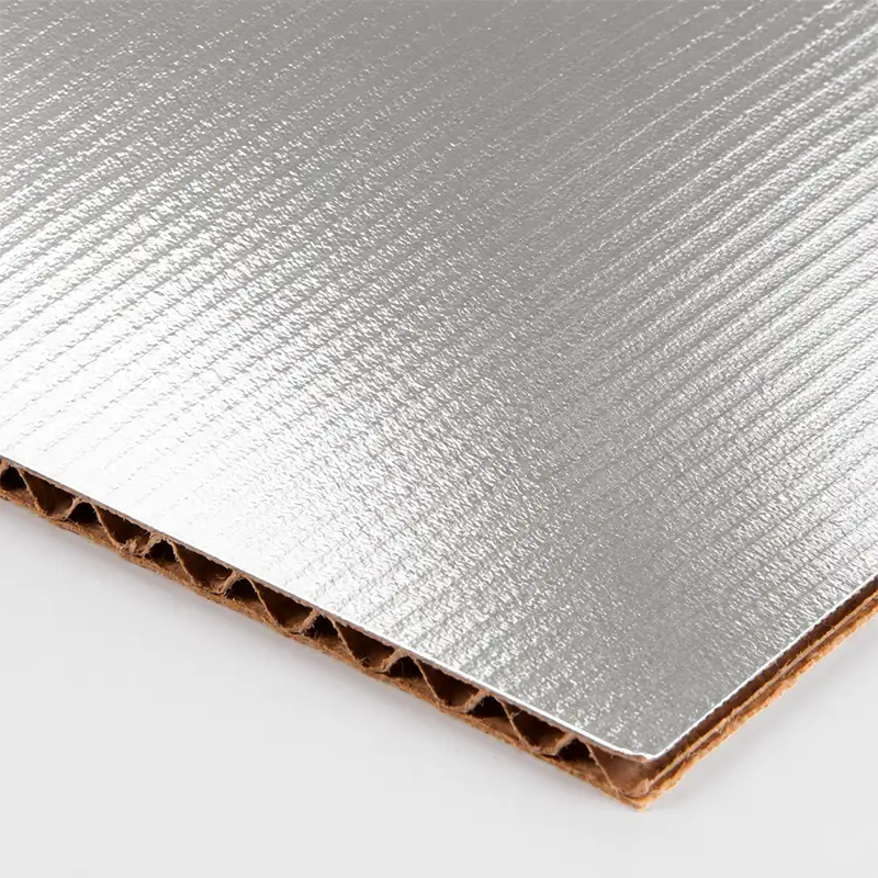 Silver foil-faced corrugated board with visible fluted paper core for custom chocolate shipping boxes